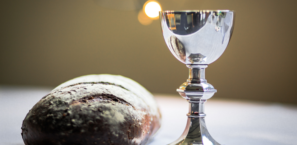 Photo of communion elements - wine in a silver cup and bread for Resurrection Sunday Holy Week Post